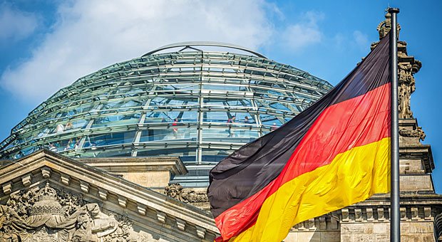Deutsche Flagge vor dem Reichstag in Berlin: Hier muss sich die Große Koalition die Zustimmung des Parlaments für ihre Pläne abholen; erst dann kann Gesetz werden, was Union und SPD im Koalitionsvertrag vereinbart haben.