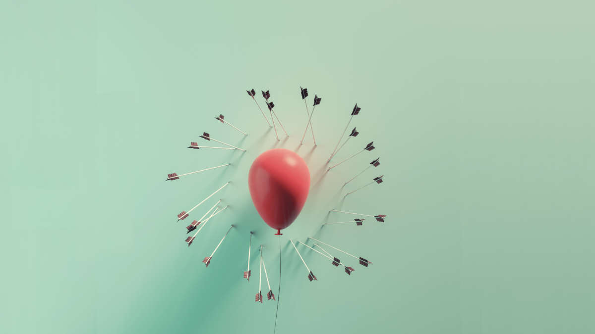 Ein Luftballon, um ihn rum viele Pfeile, aber keiner hat den Ballon getroffen.